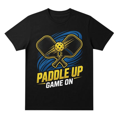  black cotton t-shirt featuring a yellow pickleball paddle graphic with the text Paddle Up Game On.