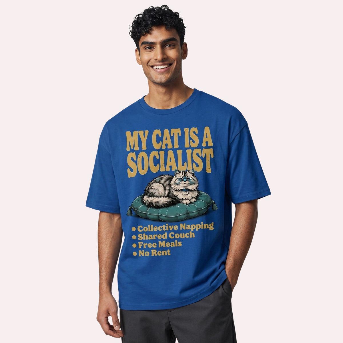  blue cotton graphic tee featuring a cat illustration and My Cat Is a Socialist text on a male model