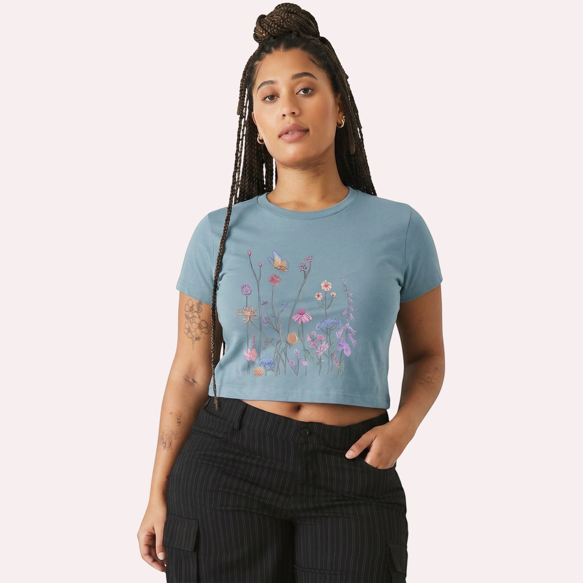  women's blue micro rib crop tee featuring a colorful wildflower and butterfly graphic print.