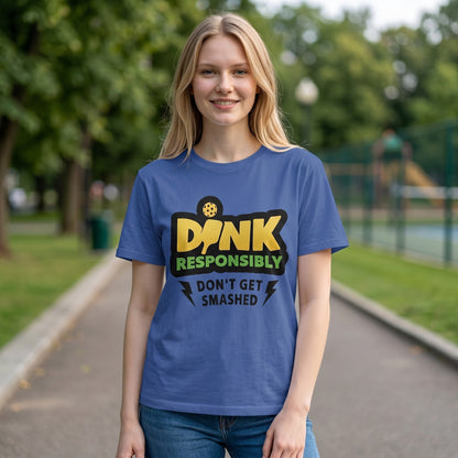 blue unisex cotton t-shirt featuring a DINK Responsibly pickleball graphic, worn by a smiling woman.