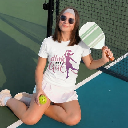  white cotton short sleeve tee with Dink Like a Girl pickleball graphic worn by a woman on a court