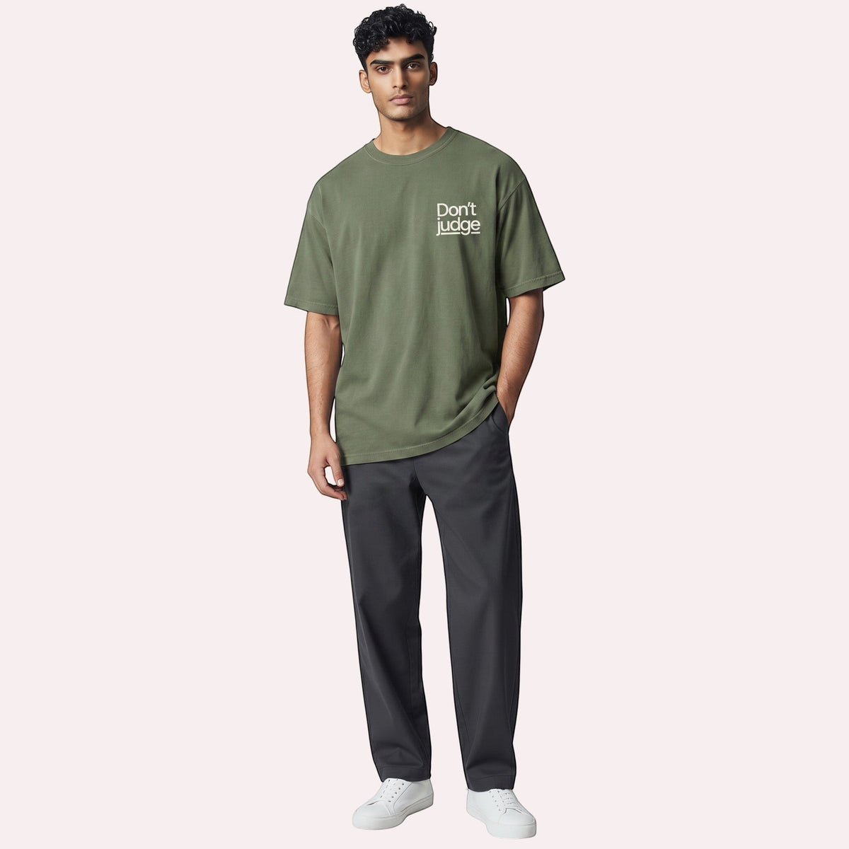  olive green oversized graphic t-shirt with Don't Judge text on chest worn by a male model