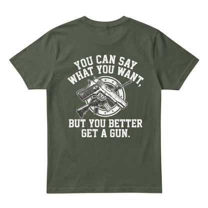  olive green cotton t-shirt featuring a white graphic of crossed firearms and bold text on the back.