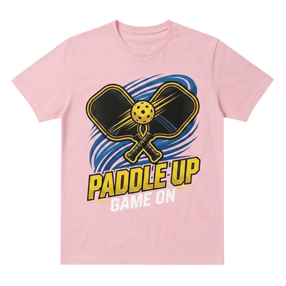  light pink cotton t-shirt featuring a Paddle Up Game On pickleball graphic with paddles and ball.