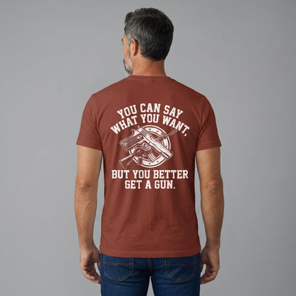  rust-colored cotton t-shirt with white graphic print featuring a gun and bold text on the back