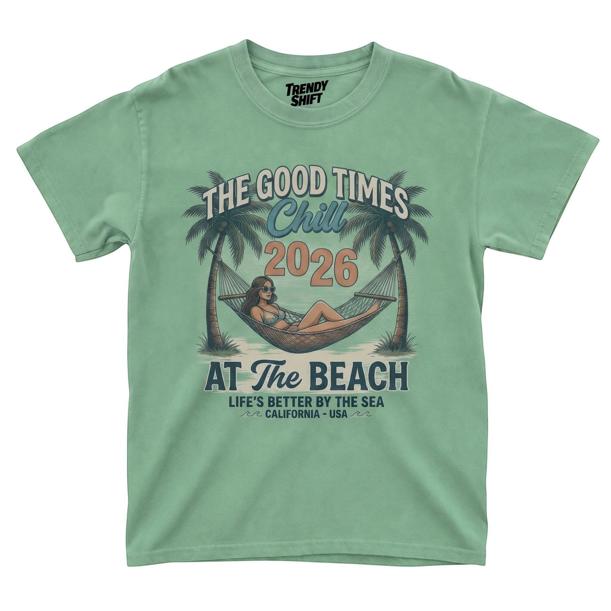  sage green graphic t-shirt featuring a woman in a hammock between palm trees with retro beach text.