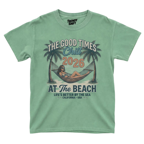  sage green graphic t-shirt featuring a woman in a hammock between palm trees with retro beach text.