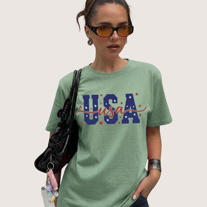  sage green unisex cotton t-shirt with USA patriotic graphic print worn by a woman with sunglasses