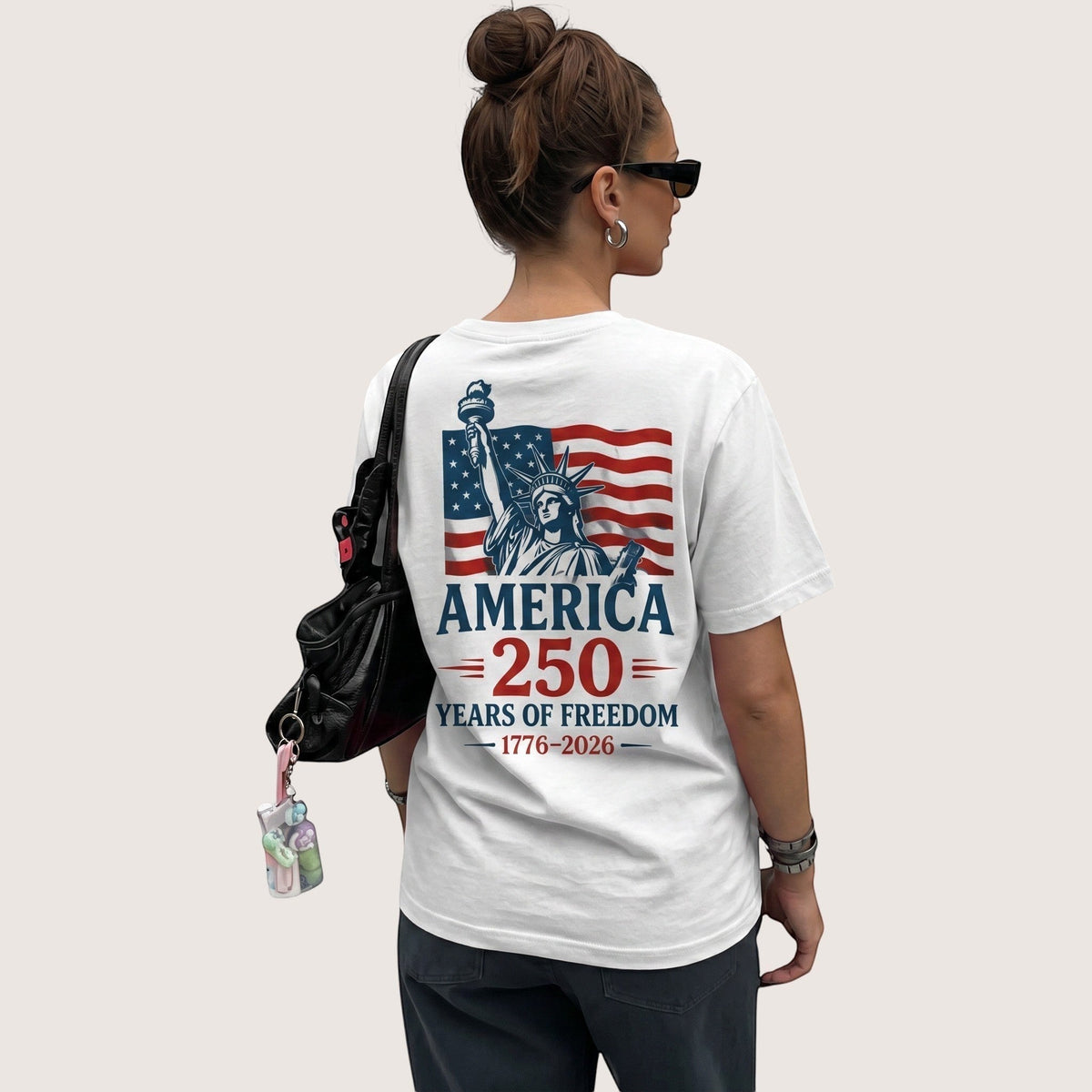  white cotton unisex t-shirt featuring a Statue of Liberty and American flag 250th anniversary graphic.