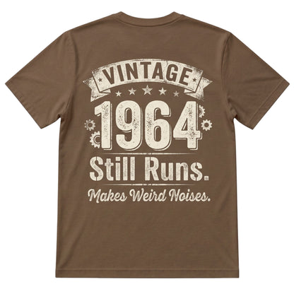  brown 100% cotton t-shirt featuring a vintage 1964 Still Runs Makes Weird Noises graphic on the back.