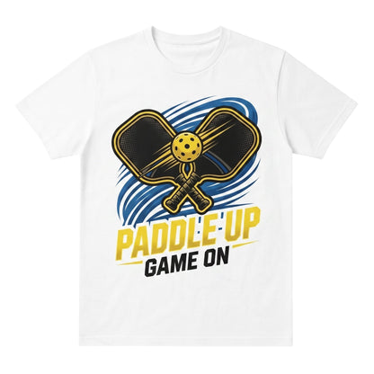  white cotton unisex t-shirt featuring a graphic of two pickleball paddles and a ball with text.