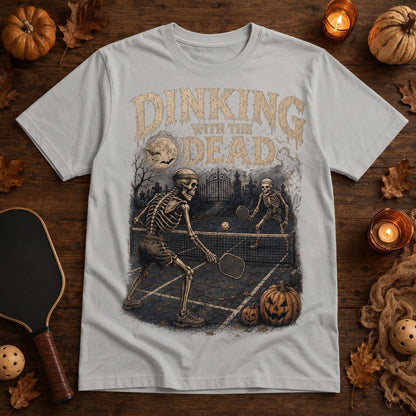  grey Halloween pickleball t-shirt with vintage skeleton graphic playing on a moonlit graveyard court