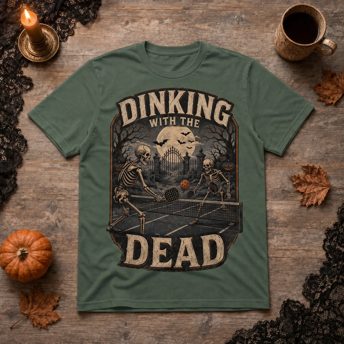  olive green cotton t-shirt featuring a vintage skeleton pickleball graphic for Halloween.